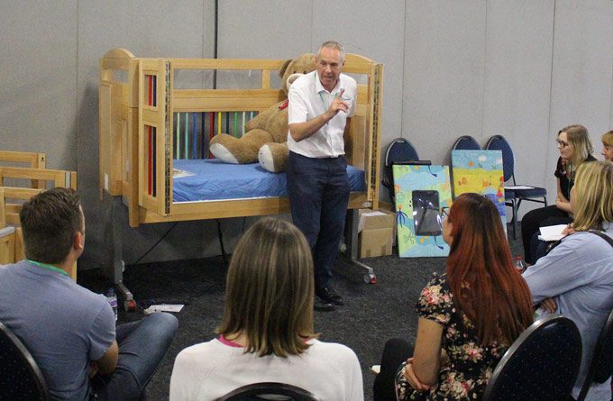 Lecture with man sitting on cot bed