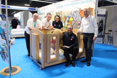 theraposture team sat on cot bed