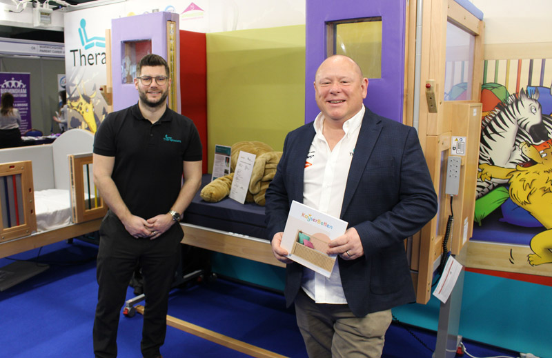 Sales team next to height adjustable cot